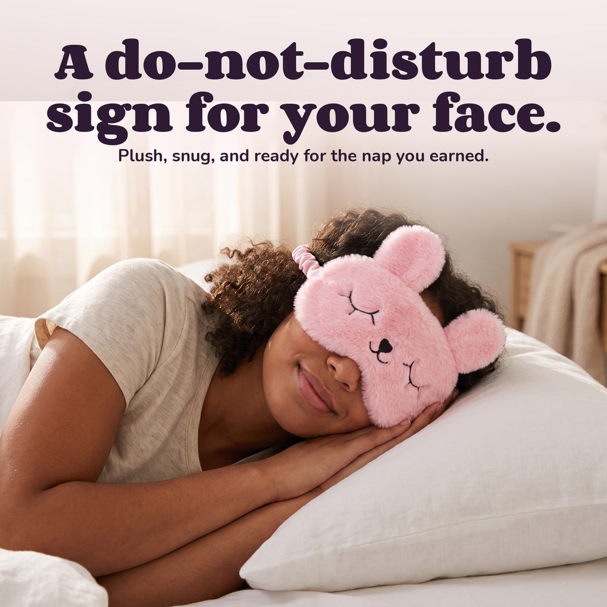 Woman using the Snugglet Nap Bunny – A do-not-disturb sign for your face.