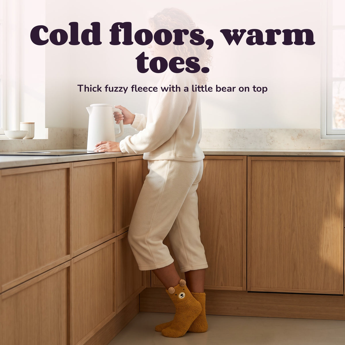 Woman using the Snugglet Bear Socks – Cold floors, warm toes.