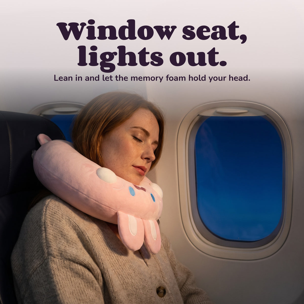 Woman using the Snugglet Flight Bunny – Window seat, lights out.
