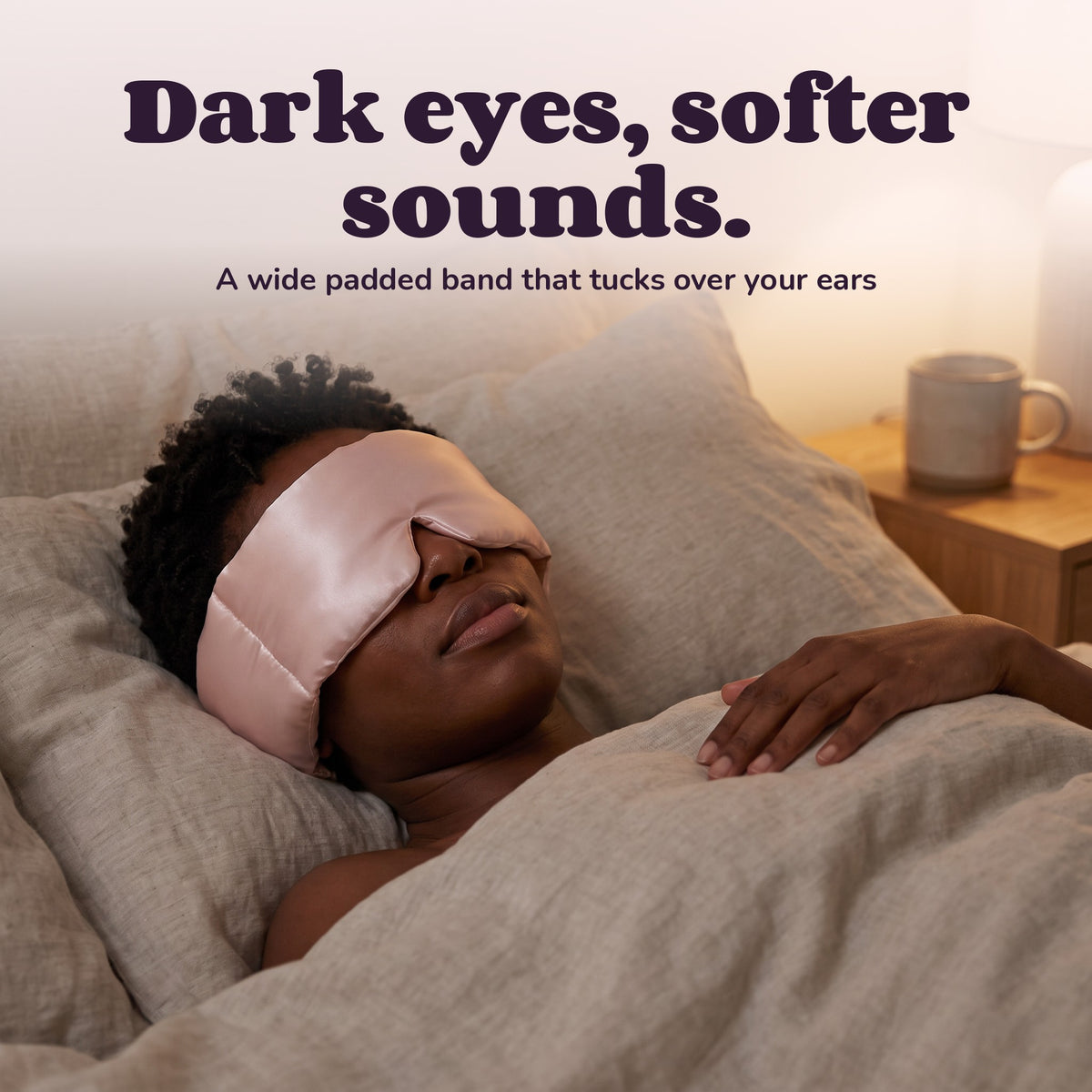 Woman using the Snugglet Hush Mask – Dark eyes, softer sounds.