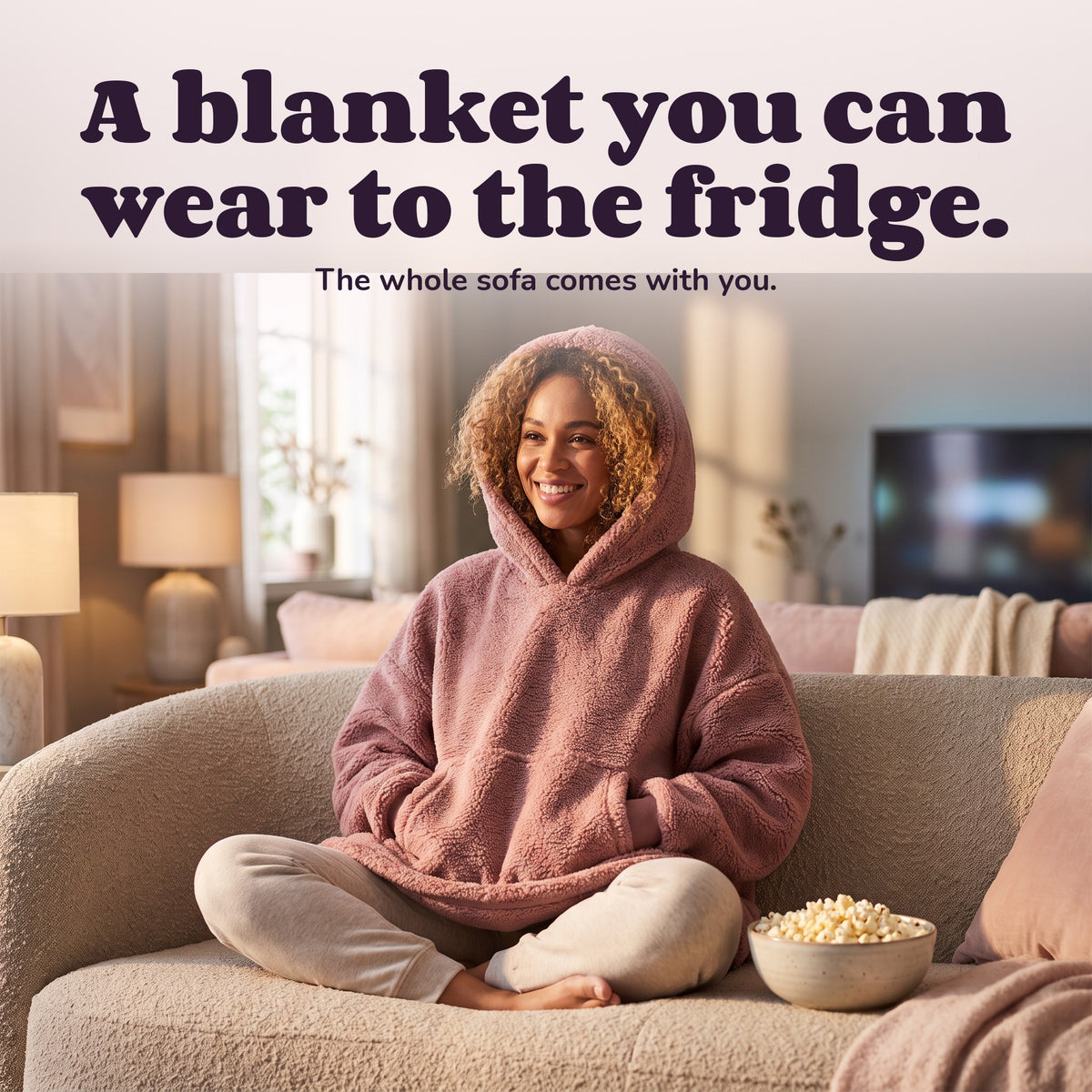 Woman using the Snugglet Hug Hoodie – A blanket you can wear to the fridge.
