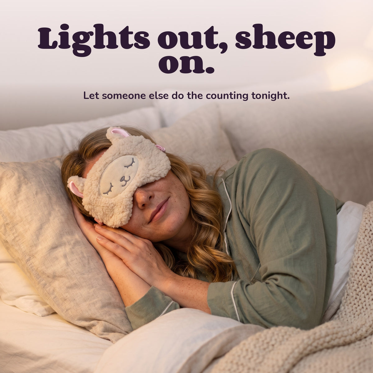 Woman using the Snugglet Sleepy Sheep – Lights out, sheep on.