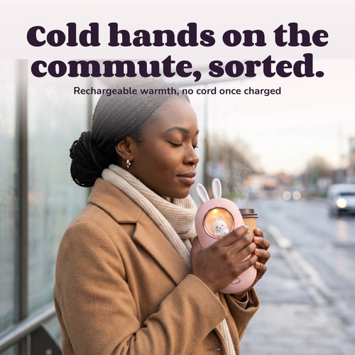 Woman using the Snugglet Bun Warmer – Cold hands on the commute, sorted.