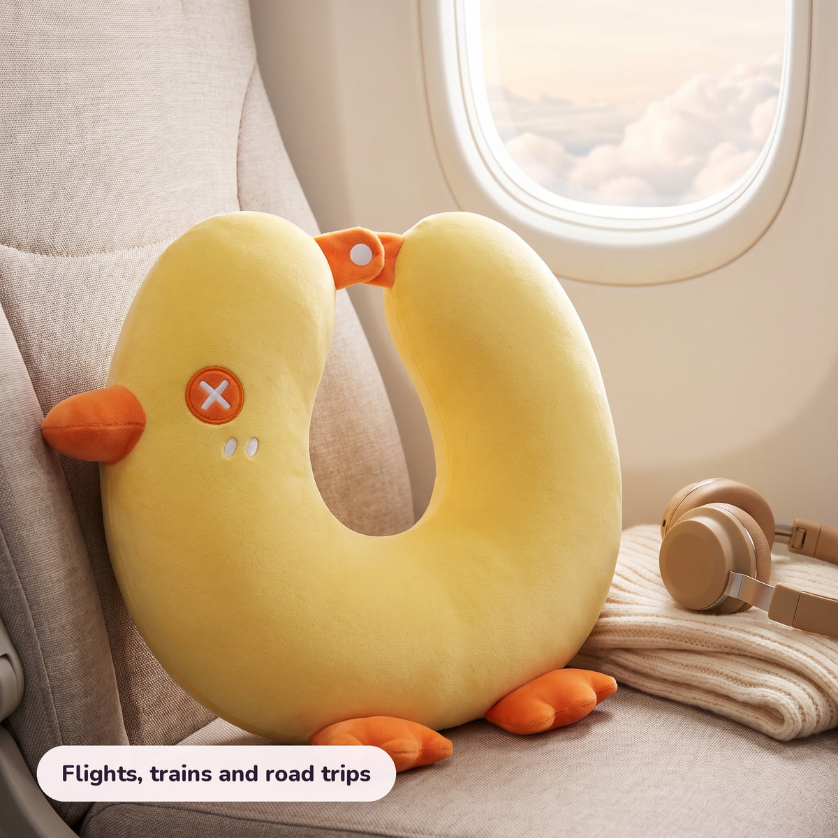 Snugglet Flight Chick on a plane window seat – Flights, trains and road trips