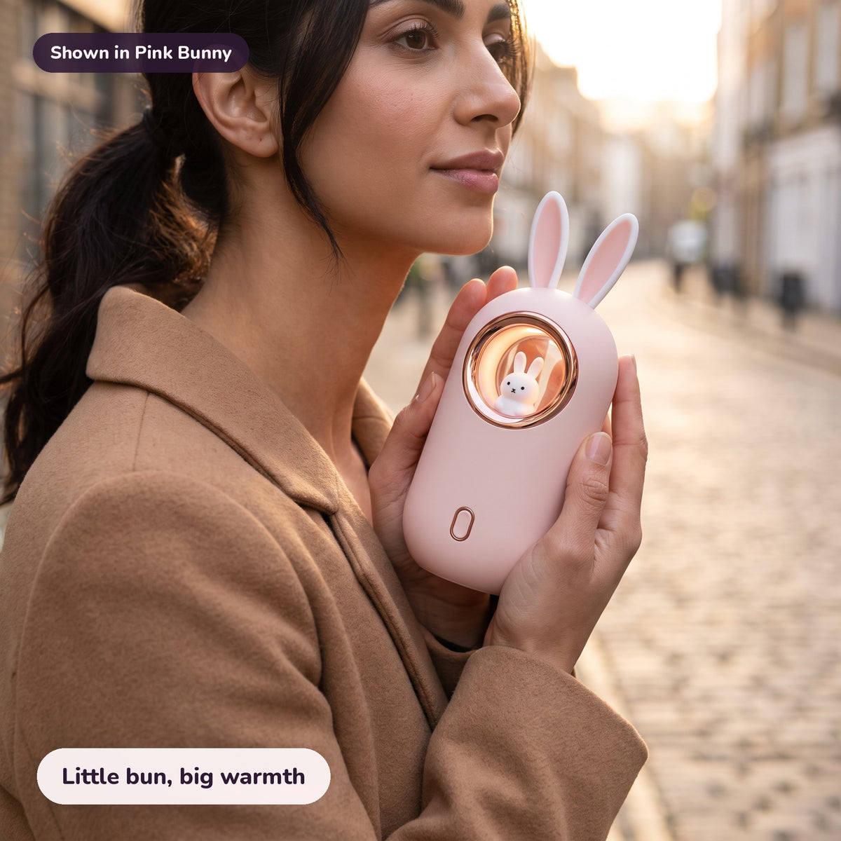 Woman using the Snugglet Bun Warmer in Pink Bunny – Little bun, big warmth