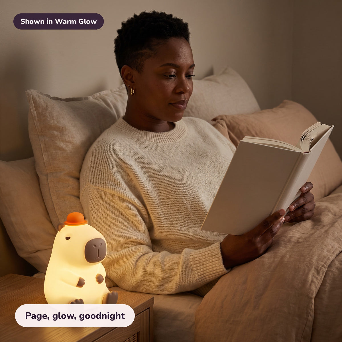 Woman using the Snugglet Capy Glow in Warm Glow – Page, glow, goodnight