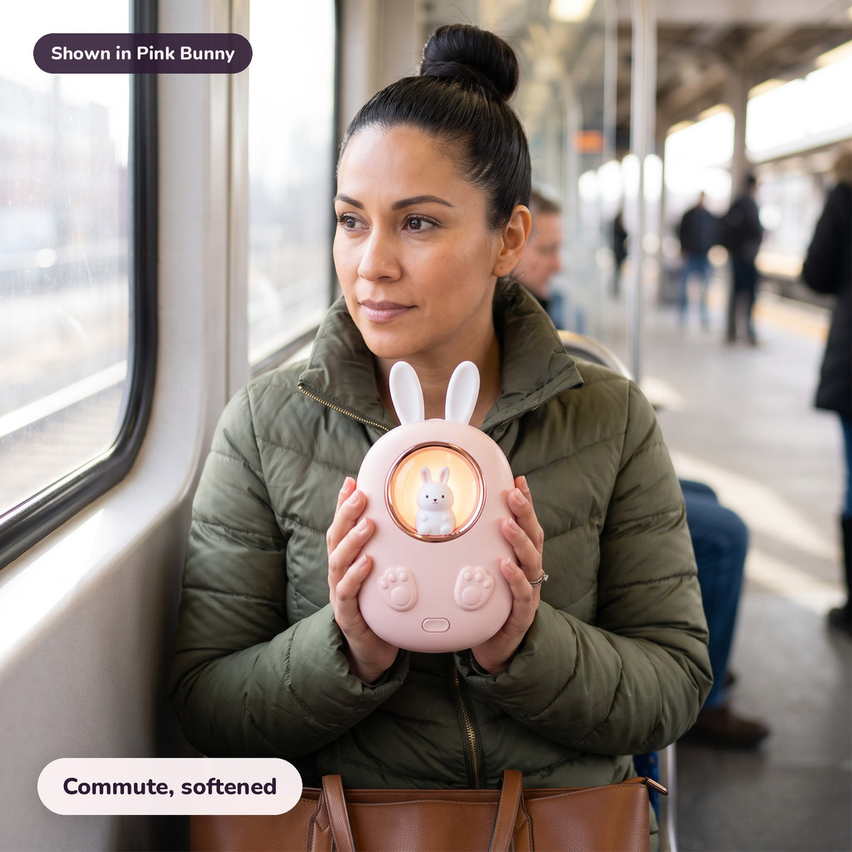 Woman using the Snugglet Bun Warmer in Pink Bunny – Commute, softened
